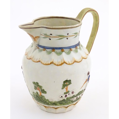 51 - A late 18th / early 19thC jug decorated in Prattware colours depicting a landscape scene with a gent... 