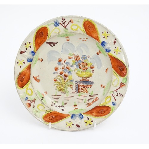 52 - A 19thC plate decorated in Pratt colours depicting flowers and foliage. Approx. 8 3/4