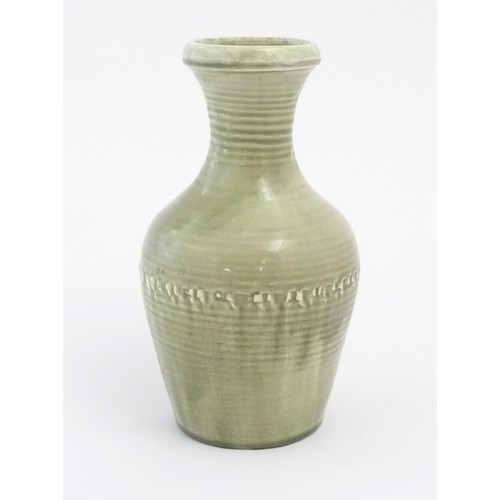 60 - A Moorcroft baluster vase with a crackle glaze and ribbed detail. Marked under. Approx. 9 1/2