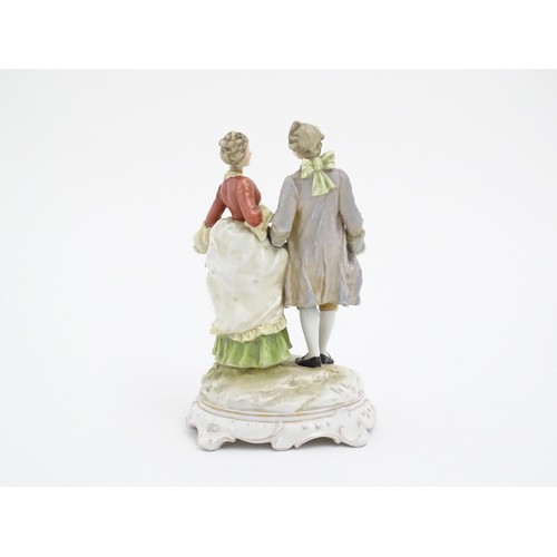 65 - A Karl Ens figural group depicting a gentleman and a lady on a shaped base. Marked under. Approx. 7 ... 