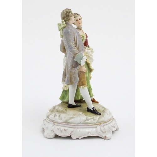 65 - A Karl Ens figural group depicting a gentleman and a lady on a shaped base. Marked under. Approx. 7 ... 