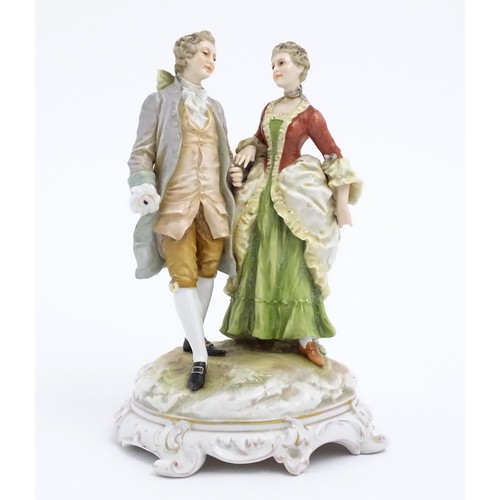 65 - A Karl Ens figural group depicting a gentleman and a lady on a shaped base. Marked under. Approx. 7 ... 