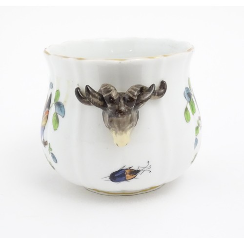 66 - A German porcelain planter with twin rams head detail, the body with hand painted decoration depicti... 