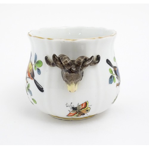 66 - A German porcelain planter with twin rams head detail, the body with hand painted decoration depicti... 