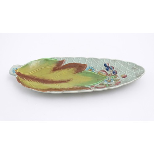 68 - A Clarice Cliff Newport pottery plate of leaf form with painted floral and foliate decoration. Marke... 