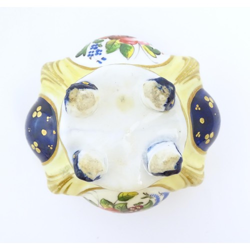 80 - A Continental porcelain inkwell of shaped form with floral and foliate detail and gilt highlights. A... 
