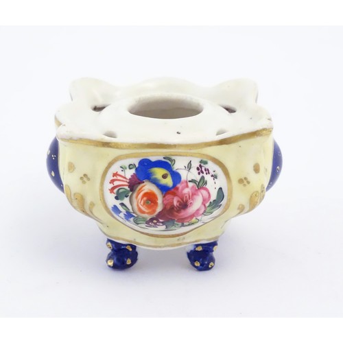 80 - A Continental porcelain inkwell of shaped form with floral and foliate detail and gilt highlights. A... 