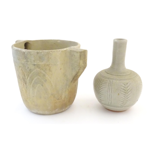 89 - Two items of studio pottery comprising a bottle vase with incised stylised foliate detail. Impressed... 