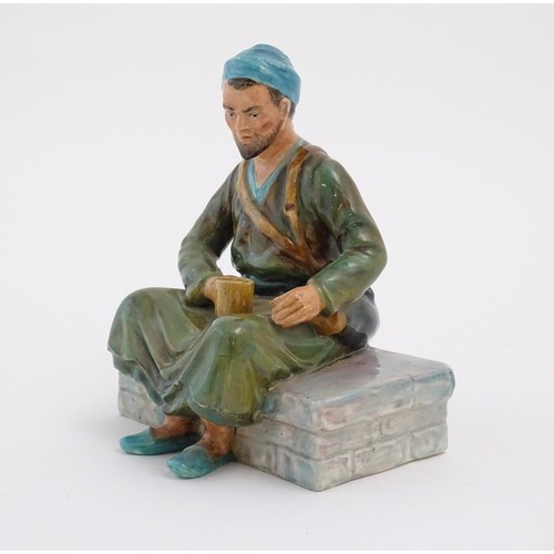 91 - A studio pottery figure modelled as an Egyptian Water Carrier, by Reg Johnson. Signed and titled to ... 