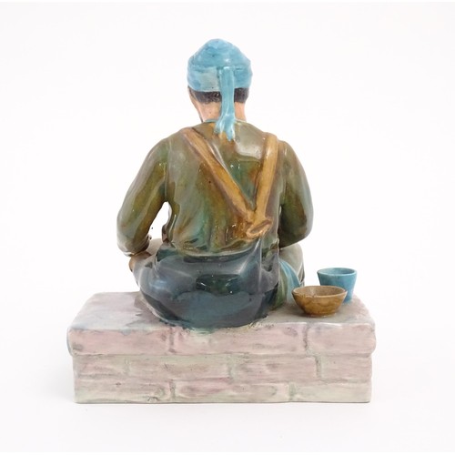 91 - A studio pottery figure modelled as an Egyptian Water Carrier, by Reg Johnson. Signed and titled to ... 