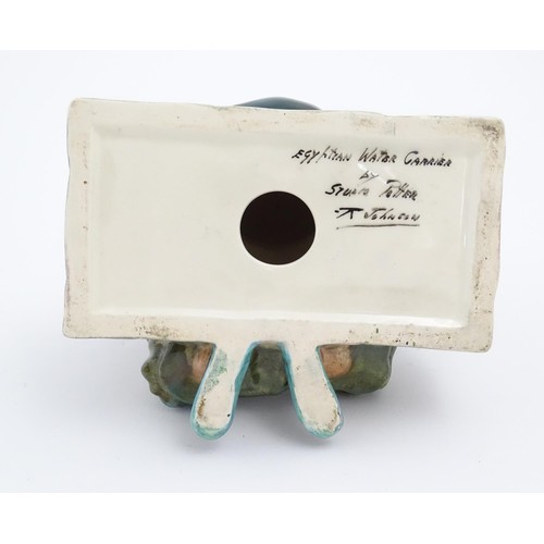 91 - A studio pottery figure modelled as an Egyptian Water Carrier, by Reg Johnson. Signed and titled to ... 