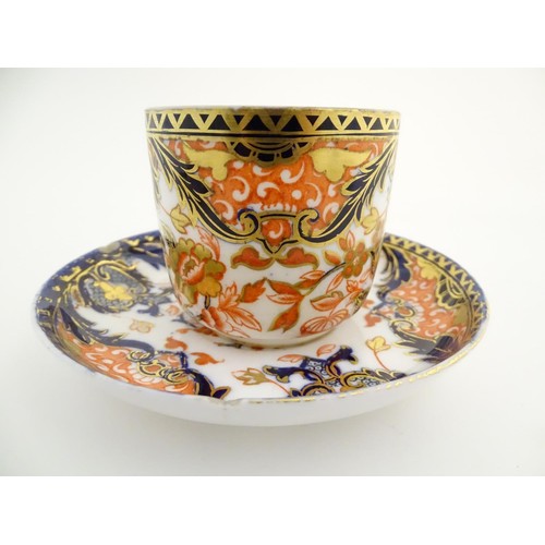 127 - A Royal Crown Derby tea cup and saucer in the Imari palette with floral and scrolling foliate decora... 