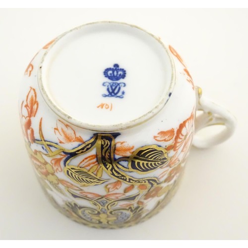 127 - A Royal Crown Derby tea cup and saucer in the Imari palette with floral and scrolling foliate decora... 