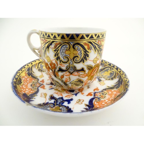 127 - A Royal Crown Derby tea cup and saucer in the Imari palette with floral and scrolling foliate decora... 