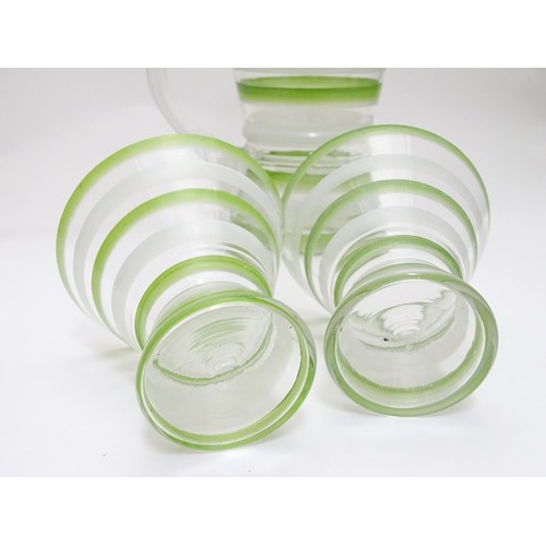 227 - An Art Deco lemonade set, with overpainted green and white banding, comprising jug and two beakers. ... 