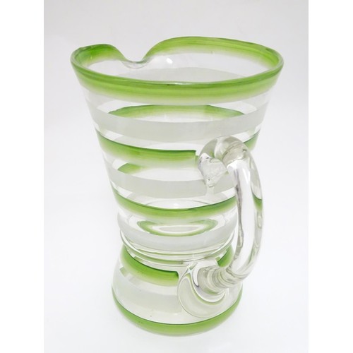 227 - An Art Deco lemonade set, with overpainted green and white banding, comprising jug and two beakers. ... 