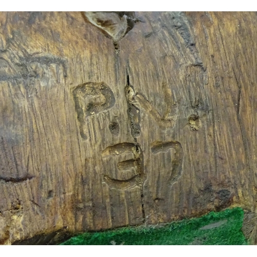 865 - A 20thC carved wooden model of bird on a rocky outcrop. Signed with initials P. N. and dated (19)37 ... 