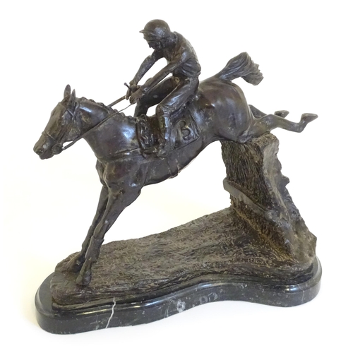 866 - A 20thC cast sculpture after David Geenty's Clearing The Last, depicting horse & jockey, on a marble... 