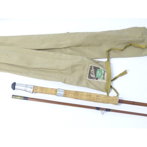 875 - Four mid 20thC fishing rods, comprising: a Milwards Flylite two-piece 7ft split cane fly rod, serial... 