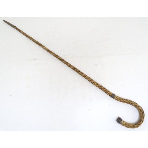 888 - An unusual continental 19thC wicker shepherd's crook with a tiered brass ferrule. Approx. 34 3/4