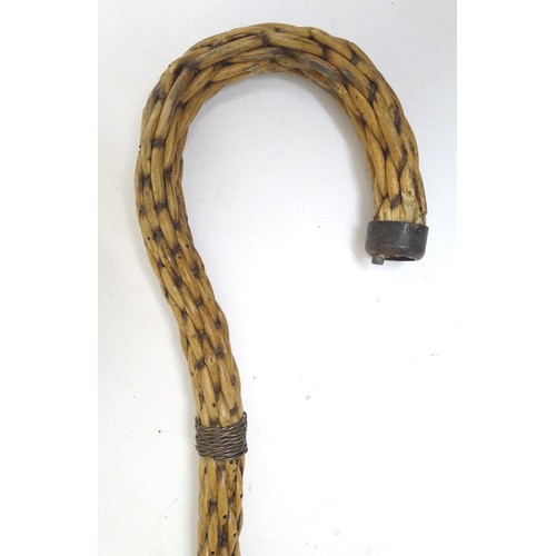 888 - An unusual continental 19thC wicker shepherd's crook with a tiered brass ferrule. Approx. 34 3/4