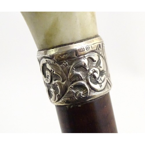 890 - A 19thC walking stick with antler handle, tapered shank, brass ferrule and silver collar, hallmarked... 