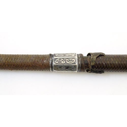 891 - A 19thC riding whip, having woven leather detail with a white metal collar & pommel with C scroll de... 