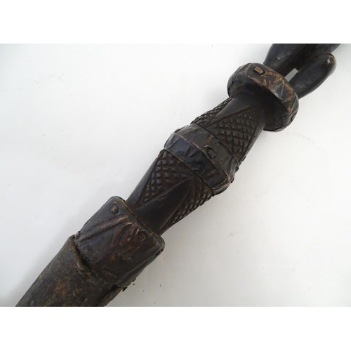 892 - Ethnographic / Native / Tribal: A carved African hardwood ceremonial staff composed of four carved f... 