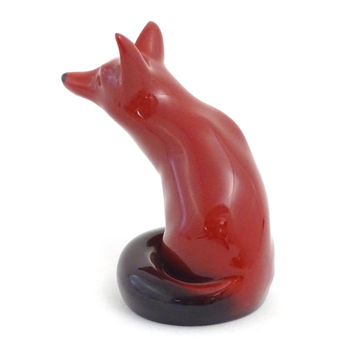 112 - A Royal Doulton flambe model of a seated fox. Marked under. Approx. 4