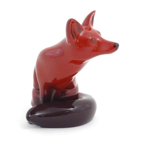 112 - A Royal Doulton flambe model of a seated fox. Marked under. Approx. 4