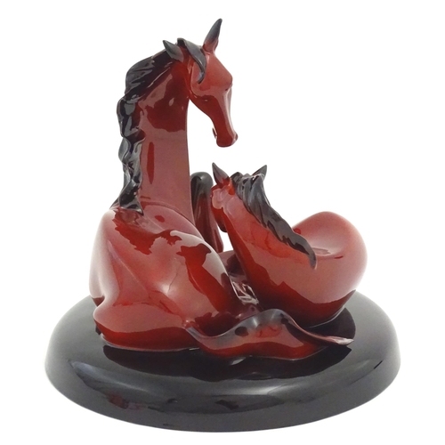 116 - A Royal Doulton flambe model of horses on a circular base, The Gift of Life, Mare and Foal. Marked u... 