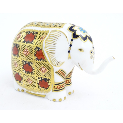 120 - A Royal Crown Derby paperweight modelled as an elephant. Marked under with gold stopper. Approx. 4