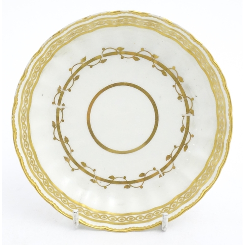 129 - A Derby fluted saucer with gilt banded detail. Marked under. Approx. 5 1/2