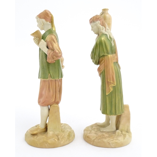 139 - A pair of Royal Worcester blush ivory figures depicting two water carriers holding vases. Marked und... 