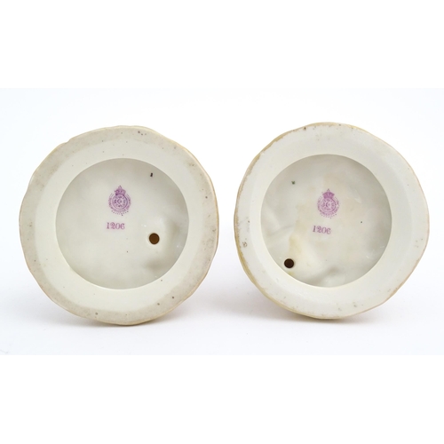 139 - A pair of Royal Worcester blush ivory figures depicting two water carriers holding vases. Marked und... 