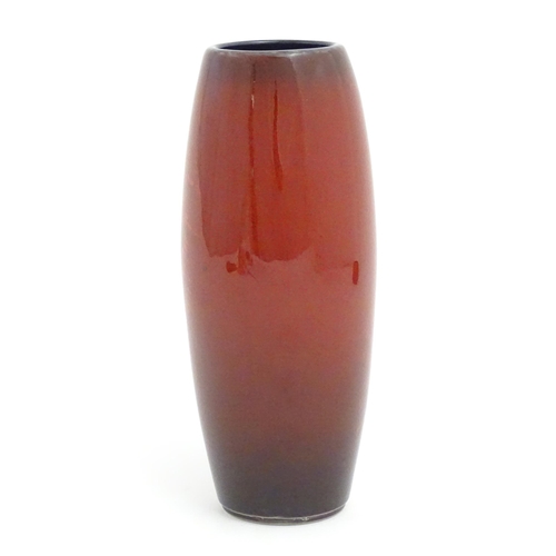 145 - An Alan Clarke studio pottery vase of cylindrical form with abstract red glaze detail. Marked under.... 