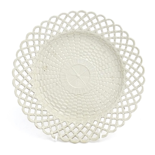 50 - A 19thC creamware plate with basket weave decoration and a reticulated border. Approx. 10 1/4