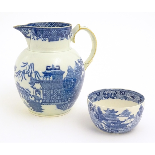 54 - A pearlware blue and white jug decorated with chinoiserie detail with figures, bridge, pagodas, etc.... 