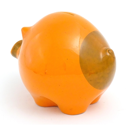 73 - A mid century Italian studio pottery piggy bank modelled as a pig with an orange glaze. Marked Balde... 