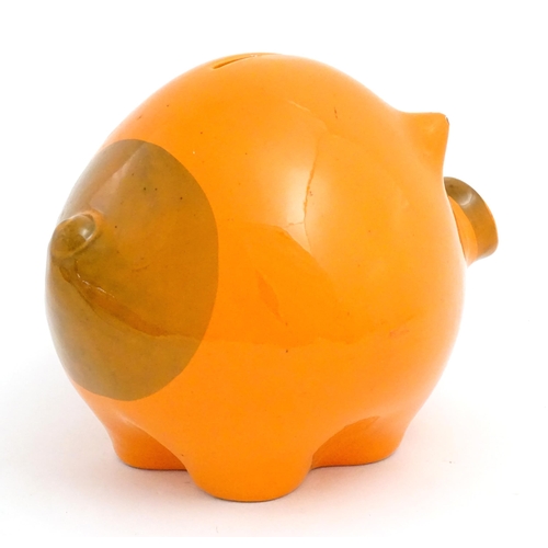 73 - A mid century Italian studio pottery piggy bank modelled as a pig with an orange glaze. Marked Balde... 