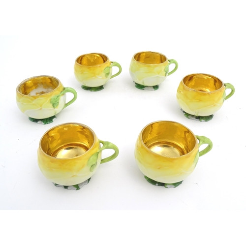 79 - A set of six German yellow rose tea cups and saucers by Car Knoll, Carlsbad, the cups with floral pe... 
