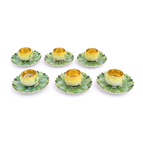 79 - A set of six German yellow rose tea cups and saucers by Car Knoll, Carlsbad, the cups with floral pe... 