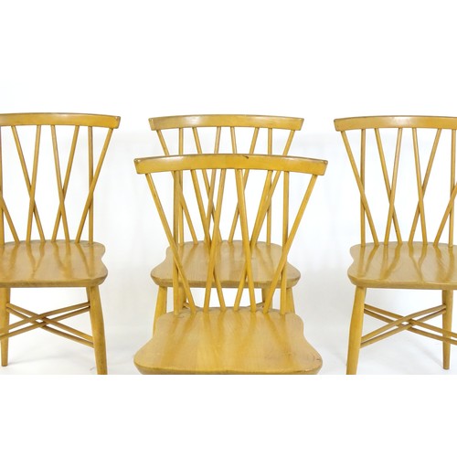 1696 - A set of four Ercol Candlestick / Shalstone dining chairs with bowed top rails above turned backrest... 