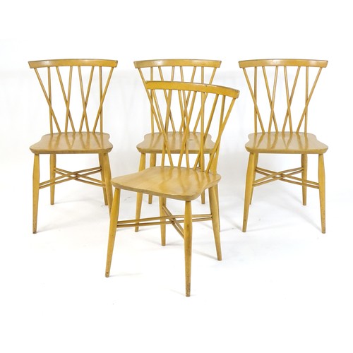 1696 - A set of four Ercol Candlestick / Shalstone dining chairs with bowed top rails above turned backrest... 