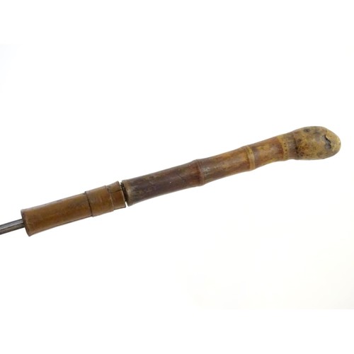 1807 - Militaria / Arms & Armour : A 19thC swordstick walking cane, the bamboo shank concealing a 22 5/8