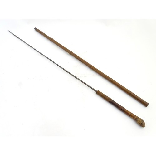 1807 - Militaria / Arms & Armour : A 19thC swordstick walking cane, the bamboo shank concealing a 22 5/8