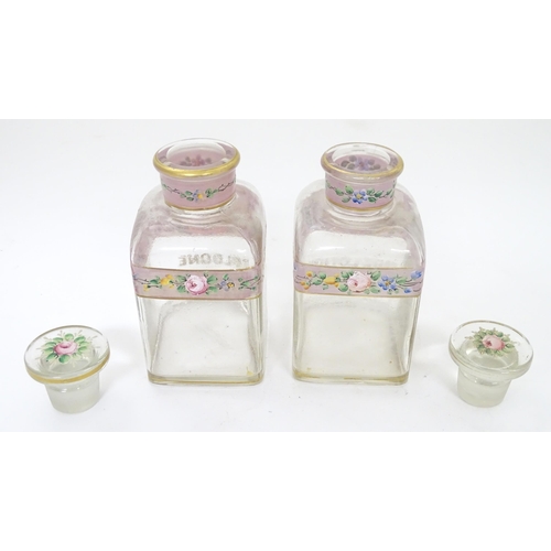 219 - A 19thC glass dressing table canisters: a pair hand painted clear glass canisters with stoppers each... 