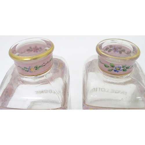 219 - A 19thC glass dressing table canisters: a pair hand painted clear glass canisters with stoppers each... 