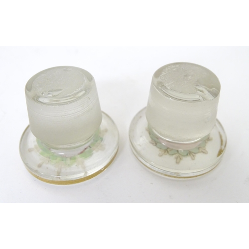 219 - A 19thC glass dressing table canisters: a pair hand painted clear glass canisters with stoppers each... 