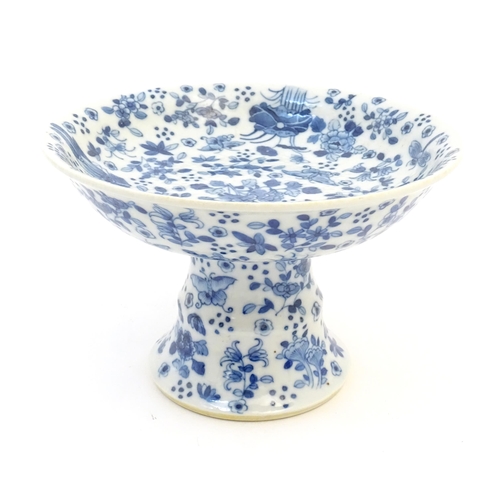 5 - A Chinese blue and white tazza with floral, foliate, butterfly and insect decoration. Approx. 5 1/2